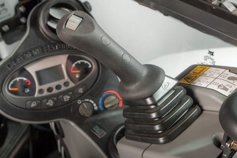 Picture of instrumentation panel and joystick inside a Bobcat compact (mini) excavator.