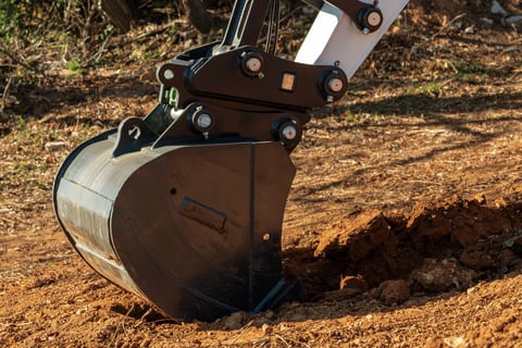 Close Up Image Of Excavator Bucket Attachment Digging Into Hard Ground