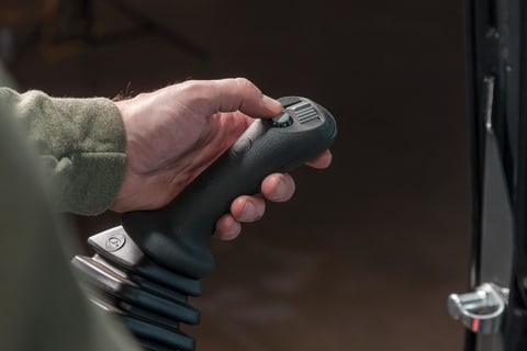 Operator using joystick controls in a Bobcat compact (mini) excavator.