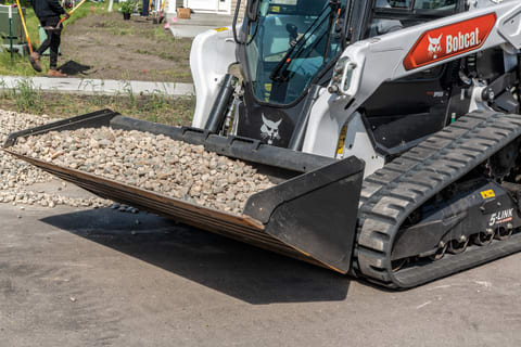 Bobcat T76 Compact Track Loader With A Bucket Full Of Rocks