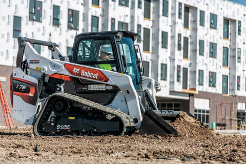 Construction Worker Using Bobcat Compact Track Loader To Grade On Construction Jobsite