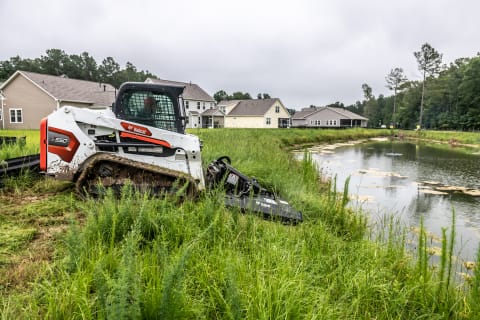 Bobcat T550 Compact Track Loader With Brushcat Attachment Mowing Ditch