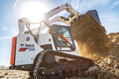 Dramatic Photo Of T740 Protected By Warranty Coverage Dumping Dirt On Jobsite