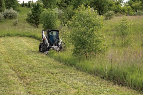 Bobcat R-Series Compact Track Loader Clearing Brush With Rotary Cutter Attachment