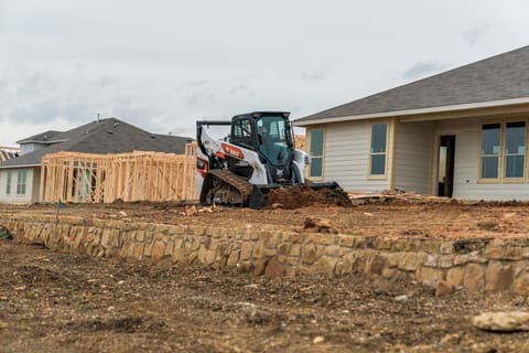 R-Series Compact Track Loader Grading Construction Jobsite With Loader Attachment