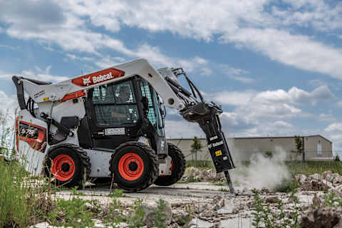 Bobcat Skid Steer Loader uses a nitrogen breaker to break up concrete.
