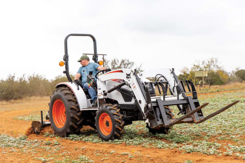 Acreage Owner Preps Field For Planting With Tiller Implement On Compact Tractor