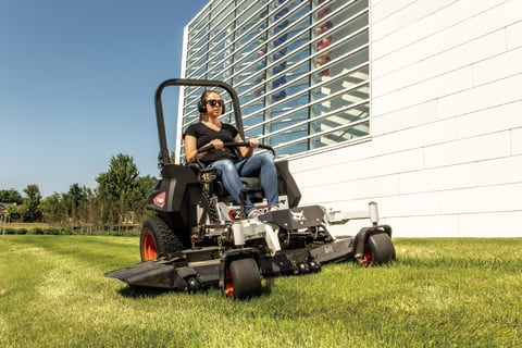 An Operator Cuts Grass Alongside a Commercial Building With the Bobcat ZT6000 Zero-Turn Mower