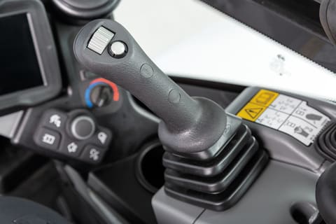 Compact (mini) excavator joystick controls.