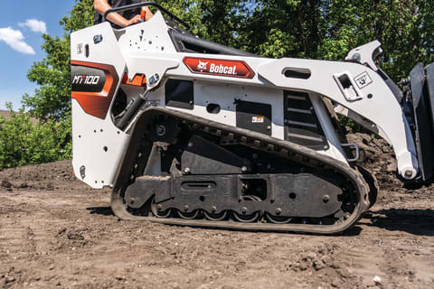 A Bobcat MT100 Mini Track Loader Traveling on the Exposed Dirt of a Jobsite