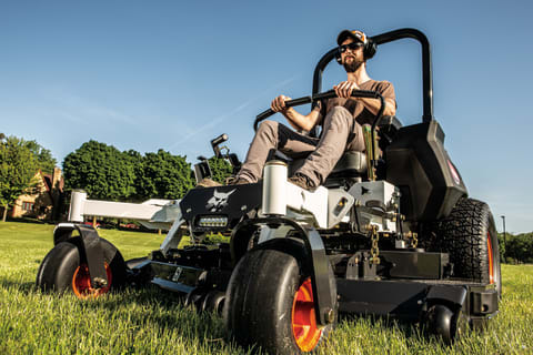 A Low-Angle Shot of an Operator Mowing Grass With the Bobcat ZT7000 Zero-Turn Mower   