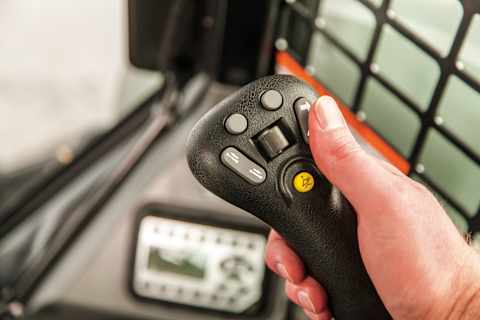 Close-up of Bobcat Selectable Joystick Controls mounted to the operator’s seat for ergonomic comfort and customizable control patterns.