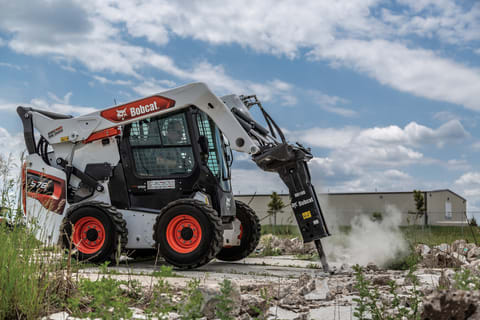 Operator Uses a Bobcat S76 Skid-Steer Loader with a Breaker Attachment to Bust Up Concrete