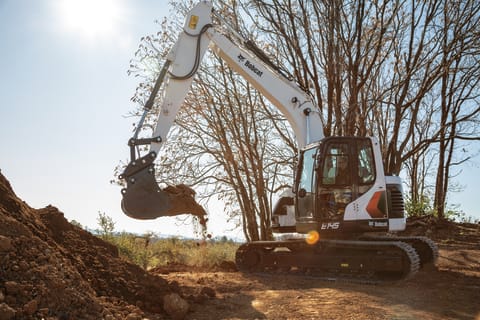 Operator Moves Dirt With Bobcat Large Excavator