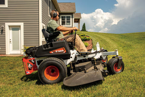 An Operator Rounds the Corner of a Home With the Bobcat ZT3000 Zero-Turn Mower 