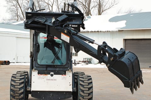  Bob-Tach Backhoe attachment allows a Bobcat skid-steer operator to dump spoil without skidding the loader. 