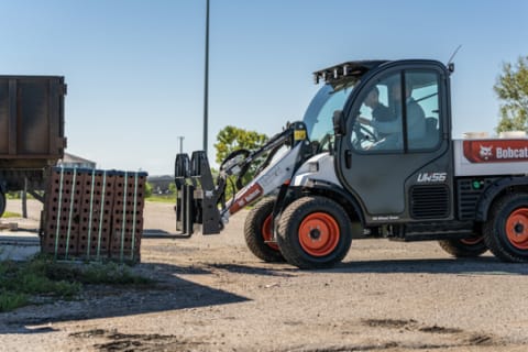 Toolcat Utility Work Machine With Pallet Fork Attachment On Jobsite