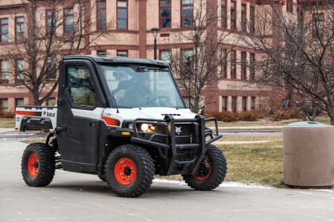 Operator Using Bobcat UV34 UTV For Grounds Maintenance