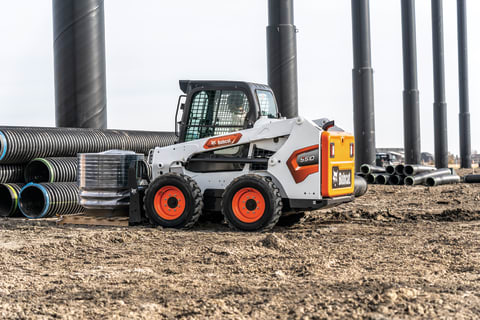 Bobcat S510 Hauling Construction Material Across Jobsite