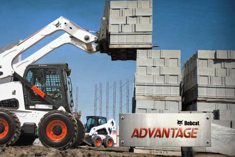 Bobcat S850 Skid-Steer Loader with pallet fork loading concrete blocks