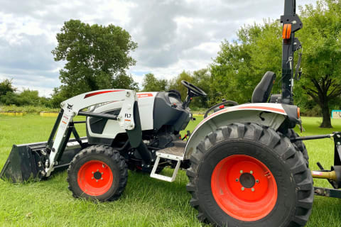 A Bobcat CT2025 compact tractor sits on the property of Sweetwater Farms HTX