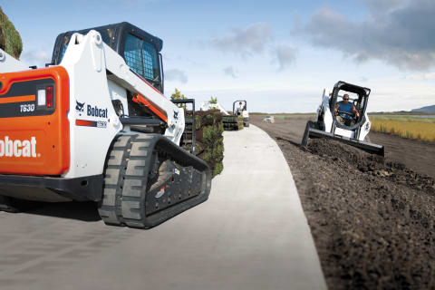 Bobcat Loaders Placing Sod Along A Roadway