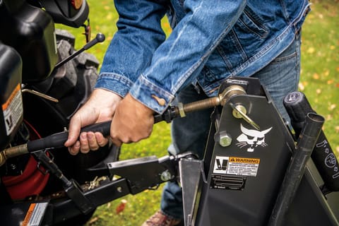 Operator Making An Adjustment With the Turnbuckle Lift Rod