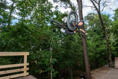 Perris Benegas catches air on a BMX bike.