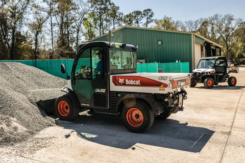 An Operator Lifts a Bucketful of Rock With a Toolcat Utility Work Machine