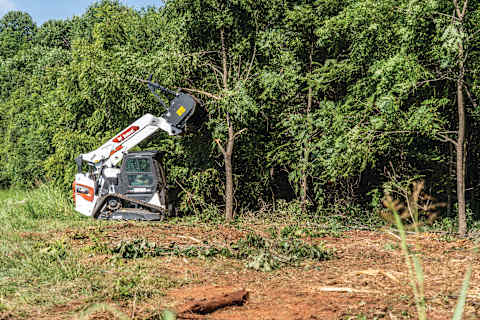 A Bobcat T86 Compact Track Loader Thins Out Small Trees Using the Drum Mulcher Attachment