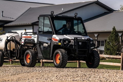 Bobcat UV34 Utility Vehicle (UTV) Pulling A Water Tank.