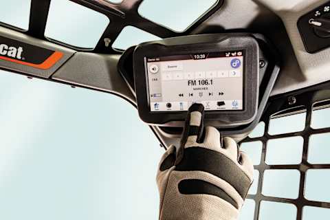 A Gloved Hand Presses the Integrated Radio Control Screen of the 7-Inch Touch Display