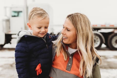 Chelsea Erdmann 6th Generation Farmer Holding Son At Jobsite