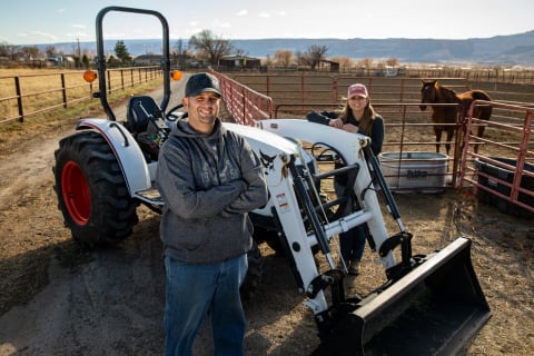 Walsdorf acreage owners stand beside Bobcat CT4045 Compact Tractor with front-end loader attachment