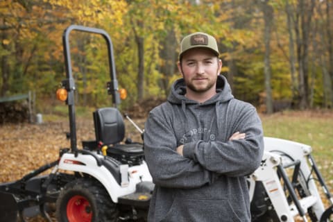 Gessler standing in front of his Bobcat CT1021 compact tractor