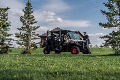 Passengers getting out of a parked Bobcat UV34XL