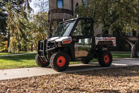 Farmer Uses Utility Vehicle With Common Tires Driving On Sidewalk