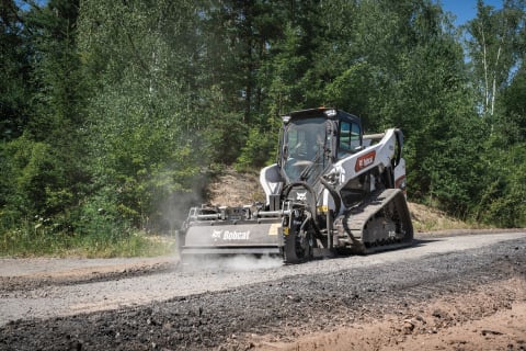 The Bobcat T86 compact track loader prepares a pathway with the super flow planer attachment.