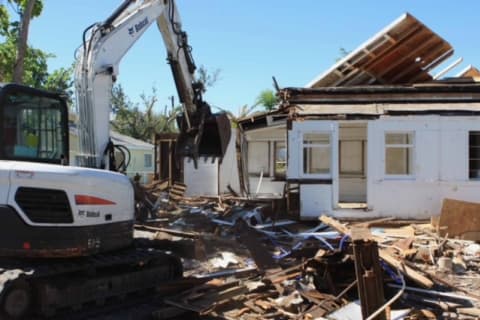 Christ In Action uses a Bobcat E50 compact excavator to demolish a home.