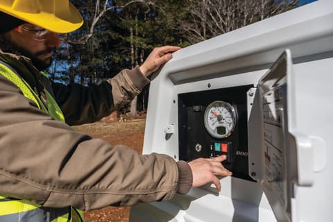 Operator Adjusts Settings on the PA185V Air Compressor Control Panel