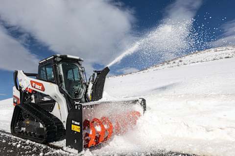 A Bobcat T86 Compact Track Loader Clears Snow From a Path With the Snowblower Attachment