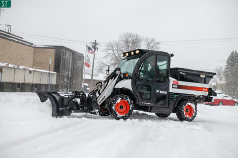 A Knoxville, Iowa, city employee clearing snow with a Bobcat Toolcat 5600 utility work machine.