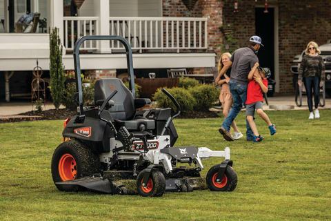 A Homeowner Takes a Family Break While His Bobcat ZT7000 Zero-Turn Mower Rests After Mowing Their Perfectly Manicured Lawn