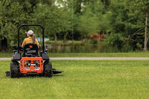 Bobcat ZT6000 Zero-Turn Mower Operator Mows Grass Near a Pond