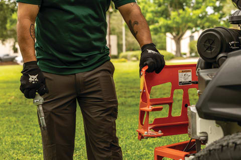 A Person Opens the Rotating Bumper on a ZT6000 Mower to Perform Service