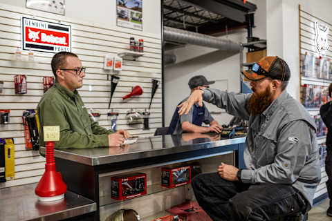 Robert Lazenby With Customer at Bobcat Dealership at Countertop