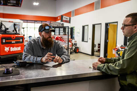 A Customer and Bobcat Dealership Employee at a Bobcat Dealership