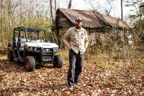 Robert Lazenby stands in front of his Bobcat UV34XL utility vehicle on his historic family farm.