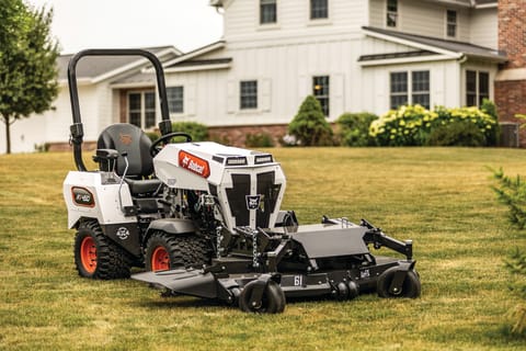 Bobcat AT450 Articulating Tractor With AirFX Mower Attachment Working in a Grassy Field