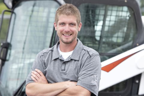 Chris Menn, owner of C-R Menn Concrete in Fremont, NE standing in front of his T770 compact track loader